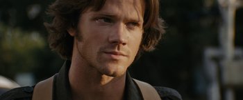 Movie still from “Friday the 13th” (2009), directed by Marcus Nispel – A person with long brown hair; Close Up shot, Over the shoulder angle