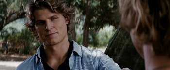 Movie still from “Friday the 13th” (2009), directed by Marcus Nispel – A person sitting in front of a tree; Close Up shot, Over the shoulder angle