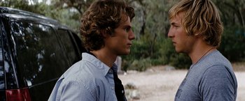 Movie still from “Friday the 13th” (2009), directed by Marcus Nispel – Two young men standing next to each other on a dirt field; Close Up shot, Over the shoulder angle