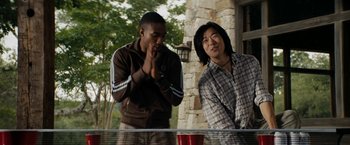 Movie still from “Friday the 13th” (2009), directed by Marcus Nispel – Two men standing next to each other near a table; Medium shot, Over the shoulder angle