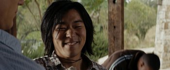 Movie still from “Friday the 13th” (2009), directed by Marcus Nispel – A man with long black hair smiling for the camera; Close Up shot, Low angle