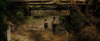 Movie still from “Friday the 13th” (2009), directed by Marcus Nispel – Two people walking on a trail under a bridge; Wide shot, Over the shoulder angle