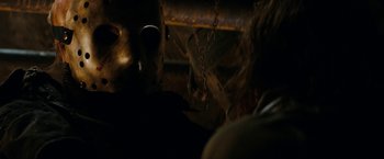 Movie still from “Friday the 13th” (2009), directed by Marcus Nispel – A person wearing a metal mask in a dark room; Close Up shot, Low angle