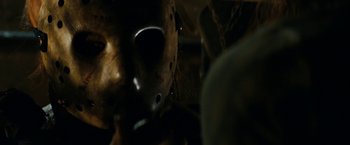 Movie still from “Friday the 13th” (2009), directed by Marcus Nispel – The face of a person wearing a hockey mask; Close Up shot, Low angle