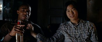 Movie still from “Friday the 13th” (2009), directed by Marcus Nispel – A man sitting next to another man in a dark room; Close Up shot, Over the shoulder angle