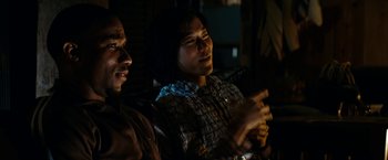 Movie still from “Friday the 13th” (2009), directed by Marcus Nispel – Two people sitting in a dark room talking to each other; Close Up shot, Over the shoulder angle