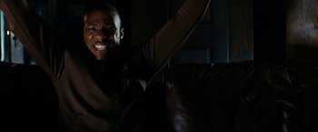 Movie still from “Friday the 13th” (2009), directed by Marcus Nispel – A man is smiling while holding his arm up; Close Up shot, Low angle