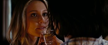Movie still from “Friday the 13th” (2009), directed by Marcus Nispel – A woman holding a glass of alcohol in her hand; Close Up shot, Over the shoulder angle