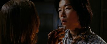Movie still from “Friday the 13th” (2009), directed by Marcus Nispel – A man holding a glass of beer while a woman looks at him; Close Up shot, Over the shoulder angle