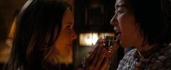 Movie still from “Friday the 13th” (2009), directed by Marcus Nispel – A woman and a man are drinking wine; Close Up shot, Over the shoulder angle