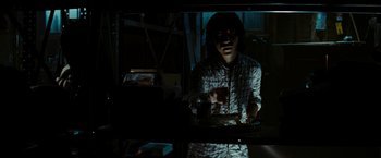 Movie still from “Friday the 13th” (2009), directed by Marcus Nispel – A person standing in front of a mirror in a room; Medium shot, Low angle