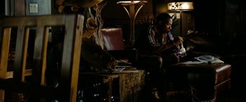 Movie still from “Friday the 13th” (2009), directed by Marcus Nispel – A man sitting at a table with a laptop in front of him; Medium shot, Over the shoulder angle