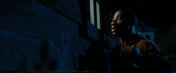 Movie still from “Friday the 13th” (2009), directed by Marcus Nispel – A man looking out of a window in a dark room; Close Up shot, Low angle