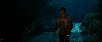 Movie still from “Friday the 13th” (2009), directed by Marcus Nispel – A man holding a flashlight while standing in the dark; Medium shot, Over the shoulder angle