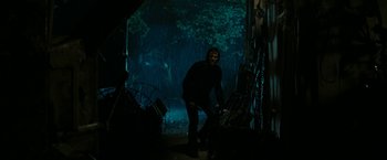 Movie still from “Friday the 13th” (2009), directed by Marcus Nispel – A man standing in the dark in front of trees; Wide shot, Low angle