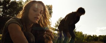 Movie still from “Friday the 13th” (2009), directed by Marcus Nispel – A woman holding a flower in her hand; Close Up shot, Over the shoulder angle