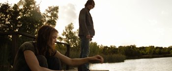 Movie still from “Friday the 13th” (2009), directed by Marcus Nispel – A man and a woman standing next to a body of water; Medium shot, Over the shoulder angle