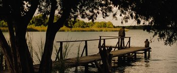 Movie still from “Friday the 13th” (2009), directed by Marcus Nispel – Two people standing on a pier near a body of water; Extreme Wide shot, Over the shoulder angle