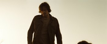 Movie still from “Friday the 13th” (2009), directed by Marcus Nispel – A man with long brown hair wearing a brown jacket; Medium shot, Low angle