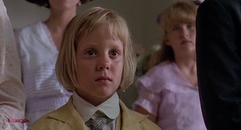 Movie still from “Fried Green Tomatoes” (1991), directed by Jon Avnet – A young child with a suit and a tie; Close Up shot, Low angle