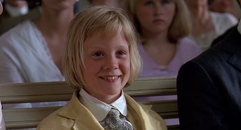 Movie still from “Fried Green Tomatoes” (1991), directed by Jon Avnet – A little girl sitting in front of a group of people; Close Up shot, Low angle