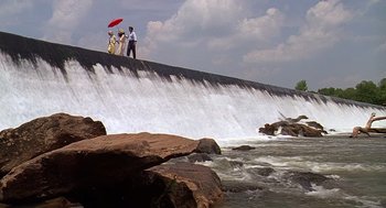 Movie still from “Fried Green Tomatoes” (1991), directed by Jon Avnet – Three people are standing on the side of a waterfall; Extreme Wide shot, Low angle