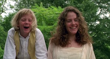 Movie still from “Fried Green Tomatoes” (1991), directed by Jon Avnet – Two women smiling and laughing in a wooded area; Close Up shot, Low angle