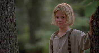 Movie still from “Fried Green Tomatoes” (1991), directed by Jon Avnet – A little girl with blonde hair wearing a brown shirt and brown suspenders; Close Up shot, Over the shoulder angle