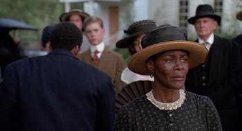 Movie still from “Fried Green Tomatoes” (1991), directed by Jon Avnet – An older black woman wearing a hat and a dress; Close Up shot, Over the shoulder angle