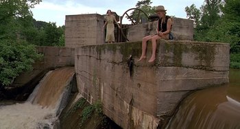 Movie still from “Fried Green Tomatoes” (1991), directed by Jon Avnet – Two women sitting on the side of a wall; Wide shot, Low angle