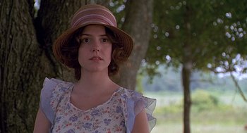 Movie still from “Fried Green Tomatoes” (1991), directed by Jon Avnet – A young woman wearing a hat in front of a tree; Close Up shot, Low angle