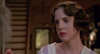 Movie still from “Fried Green Tomatoes” (1991), directed by Jon Avnet – A young woman in a white dress looking at the camera; Close Up shot, Low angle