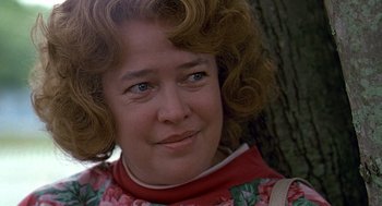 Movie still from “Fried Green Tomatoes” (1991), directed by Jon Avnet – A person with curly hair wearing a dress; Close Up shot, Low angle
