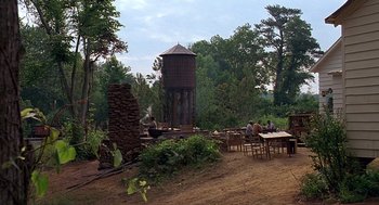 Movie still from “Fried Green Tomatoes” (1991), directed by Jon Avnet – People sitting at a table in the middle of a forest; Extreme Wide shot, High angle
