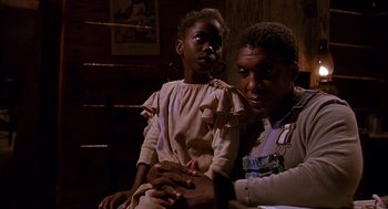 Movie still from “Fried Green Tomatoes” (1991), directed by Jon Avnet – A man and a woman sitting next to each other in a room; Medium shot, Low angle