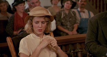 Movie still from “Fried Green Tomatoes” (1991), directed by Jon Avnet – A woman wearing a hat is holding a key; Close Up shot, Over the shoulder angle
