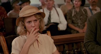 Movie still from “Fried Green Tomatoes” (1991), directed by Jon Avnet – A woman in a hat is sitting in a courtroom; Close Up shot, Over the shoulder angle