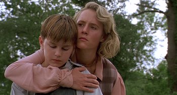 Movie still from “Fried Green Tomatoes” (1991), directed by Jon Avnet – A woman holding a young boy in her arms; Close Up shot, Low angle