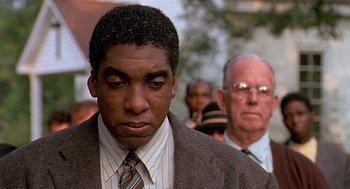 Movie still from “Fried Green Tomatoes” (1991), directed by Jon Avnet – A person wearing a suit and tie; Close Up shot, Low angle