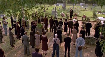 Movie still from “Fried Green Tomatoes” (1991), directed by Jon Avnet – A group of people standing around a cemetery; Extreme Wide shot, High angle