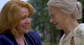 Movie still from “Fried Green Tomatoes” (1991), directed by Jon Avnet – A woman and an older woman smiling at each other; Close Up shot, Over the shoulder angle