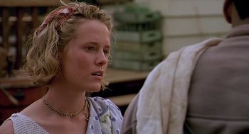 Movie still from “Fried Green Tomatoes” (1991), directed by Jon Avnet – A young woman with blonde curly hair wearing a polka dot shirt; Close Up shot, Over the shoulder angle