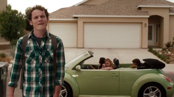 Movie still from “Fright Night” (2011), directed by Craig Gillespie – A man standing in front of a green volkswagon convertible; Medium shot, Over the shoulder angle