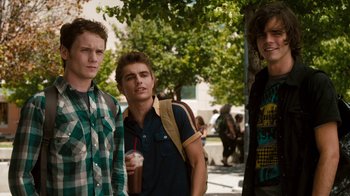 Movie still from “Fright Night” (2011), directed by Craig Gillespie – A group of young men standing next to each other on a sidewalk; Medium shot, Over the shoulder angle