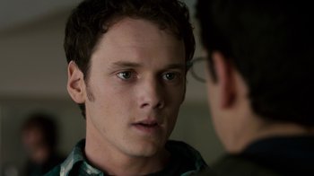 Movie still from “Fright Night” (2011), directed by Craig Gillespie – A young man looking at the camera while talking to another man; Close Up shot, Over the shoulder angle