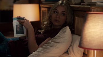 Movie still from “Fright Night” (2011), directed by Craig Gillespie – A woman laying in bed holding a camera; Medium shot, Over the shoulder angle