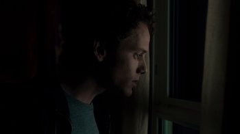 Movie still from “Fright Night” (2011), directed by Craig Gillespie – A man looking out of a window at night; Close Up shot, Low angle
