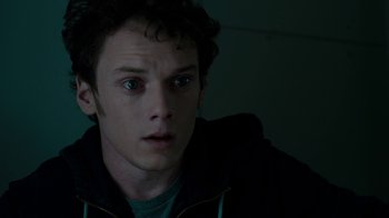Movie still from “Fright Night” (2011), directed by Craig Gillespie – A young man with green eyes stares into the camera; Close Up shot, High angle
