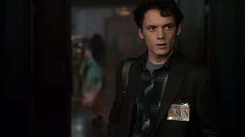 Movie still from “Fright Night” (2011), directed by Craig Gillespie – A man in a suit and tie standing in a hallway; Medium shot, Over the shoulder angle