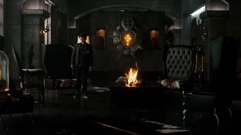 Movie still from “Fright Night” (2011), directed by Craig Gillespie – A man standing in front of a fire in a living room; Wide shot, High angle